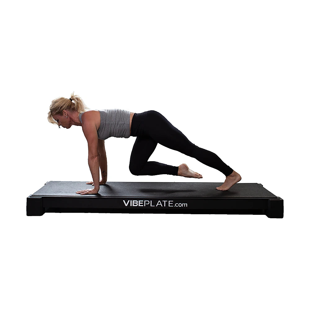 Woman performing a mountain climber on the VibePlate XL platform