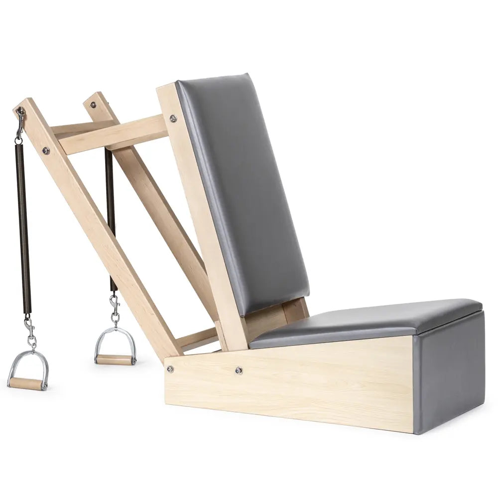 Woman performing a standing arm exercise with the Elina Pilates Baby Chair