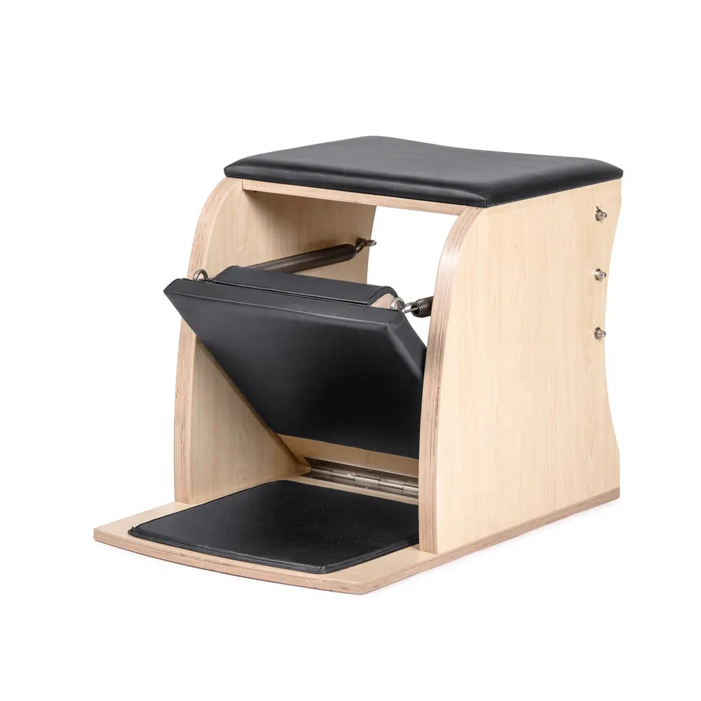 Elina Pilates Classic Wunda Chair in black shown from the side with padded pedal