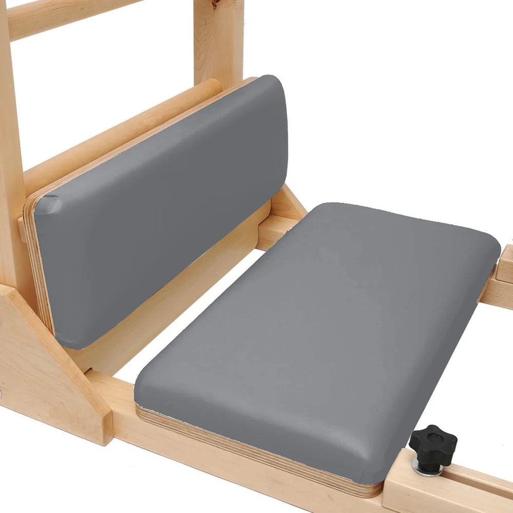 Close-up of padded foot platforms on the gray Elite Elina Pilates wooden base Ladder Barrel