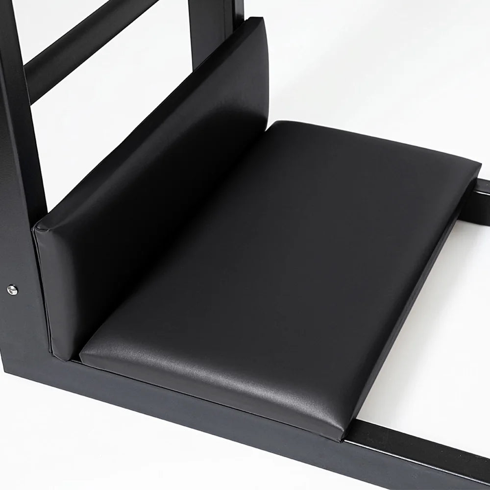 Close-up of padded foot platforms on the black Elite Elina Pilates steel base Ladder Barrel