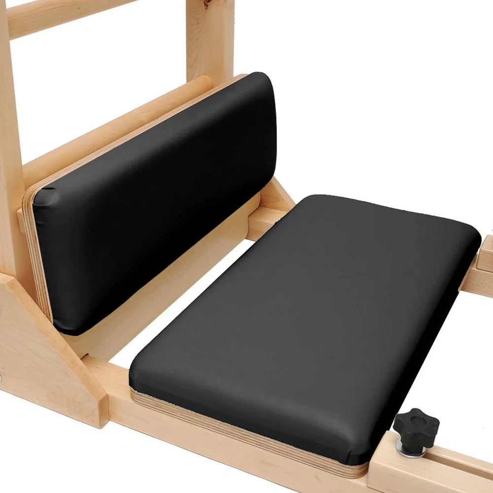Close-up of padded foot platforms on the black Elite Elina Pilates wooden base Ladder Barrel