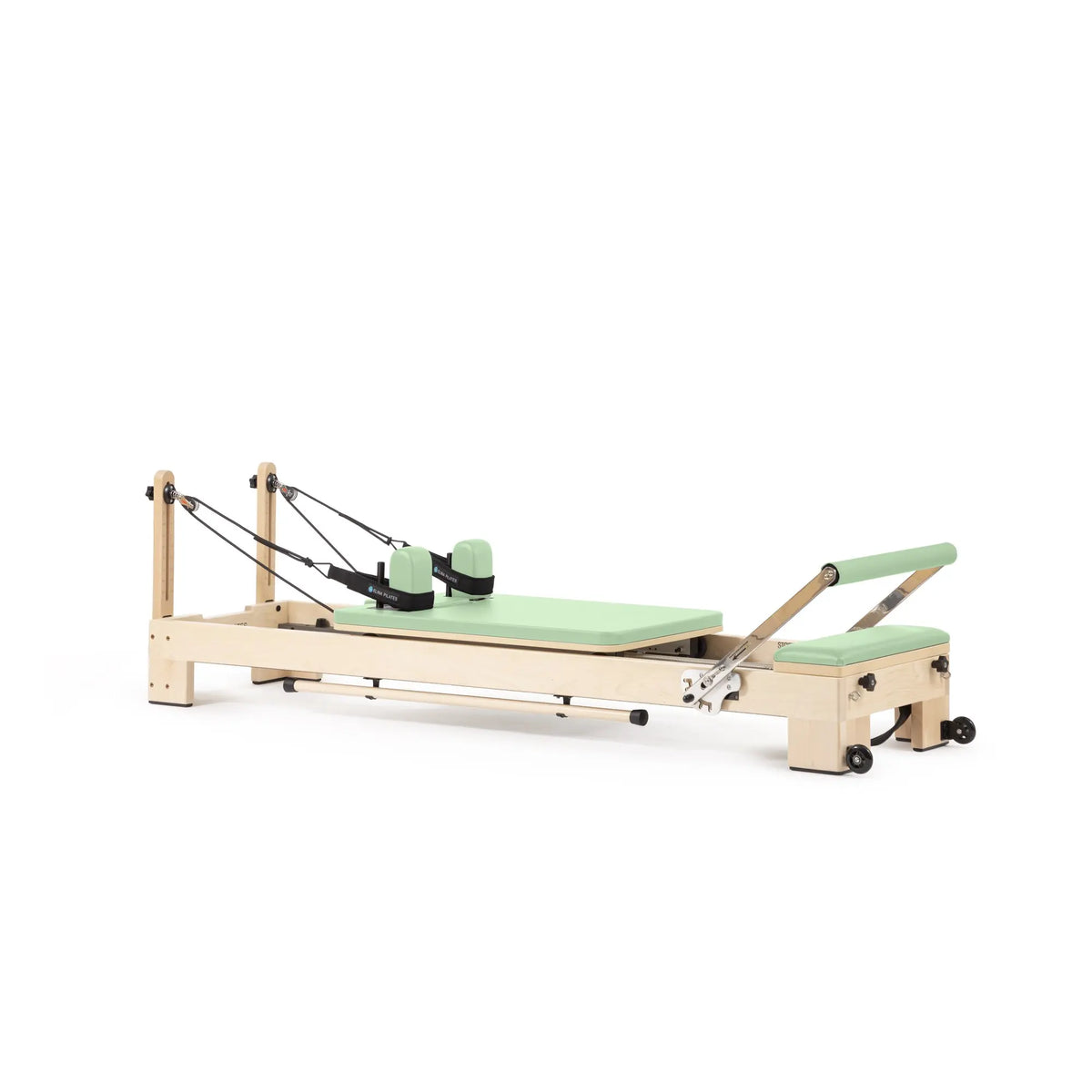 Elina Pilates Lignum wooden reformer in green, angled view