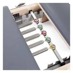 Color-coded spring system on the grey Elina Pilates Lignum Reformer with Tower