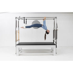Woman performing an inversion exercise on the Elina Pilates Classic Aluminum Cadillac