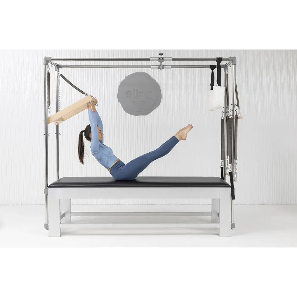 Woman performing a leg spring exercise on the Elina Pilates Classic Aluminum Cadillac