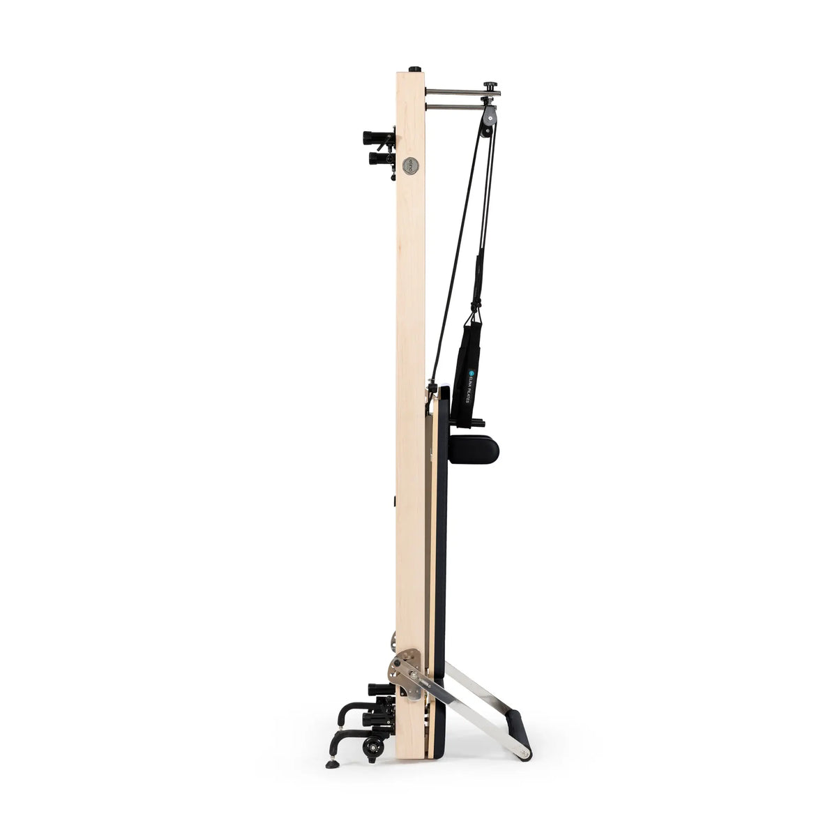 Black Elina Pilates Vertical Reformer stored upright between workouts
