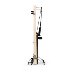 Black Elina Pilates Vertical Reformer stored upright between workouts