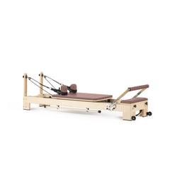 Custom-color Elina Pilates Lignum wooden reformer in Dusty Rose, angled view