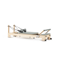 Custom-color Elina Pilates Lignum wooden reformer in Eucalyptus Green, angled view