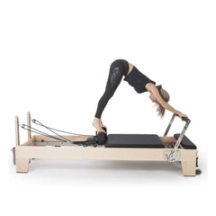 Standing Pilates exercise on the black Elina Pilates Elite Reformer