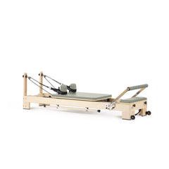 Custom-color Elina Pilates Lignum wooden reformer in Iceberg Green, angled view