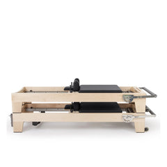 Two black Elina Pilates Elite Reformers stacked for space-saving storage