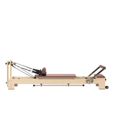 Custom-color Elina Pilates Lignum wooden reformer in Dusty Rose, full side view
