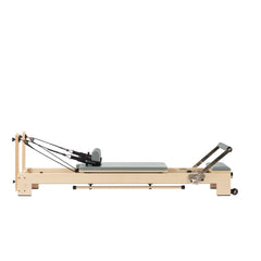 Custom-color Elina Pilates Lignum wooden reformer in Eucalyptus Green, full side view