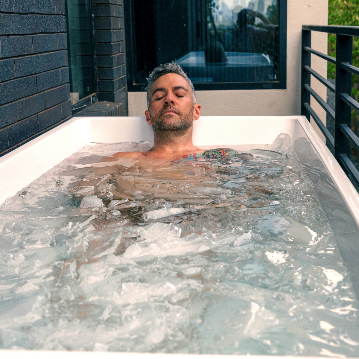 Person relaxing in the Revive Acrylic Plunge with ice