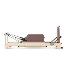 Custom-color Elina Pilates Lignum wooden reformer in Dusty Rose with sitting box