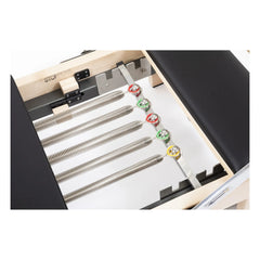 Color-coded spring system on the Elina Pilates Lignum Reformer