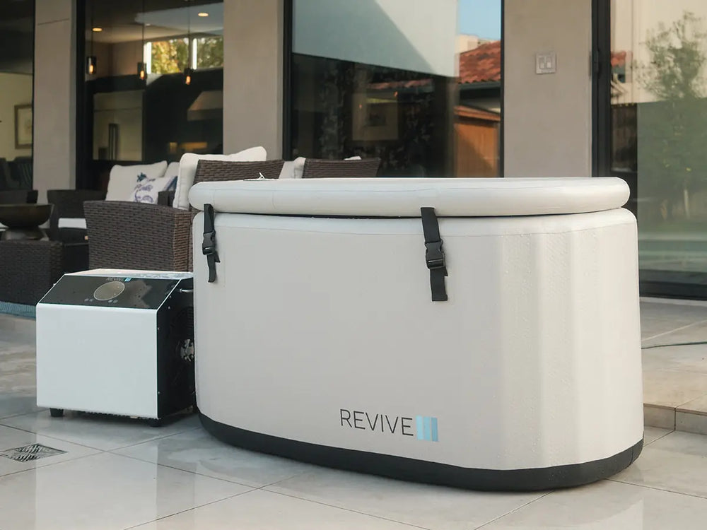 Revive inflatable cold plunge tub and external chiller installed on a covered home patio.