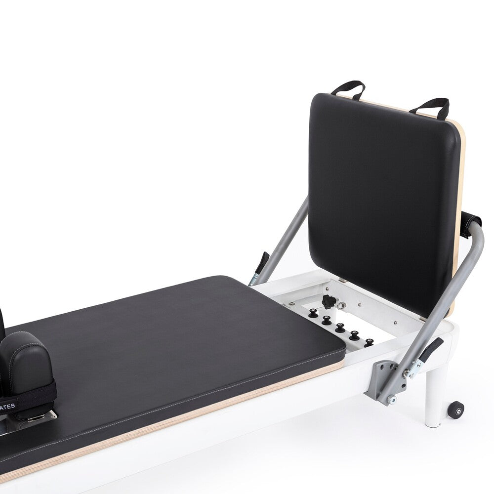 Gray jump board and adjustable footbar on the Nubium reformer