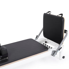 Gray jump board and adjustable footbar on the Nubium reformer
