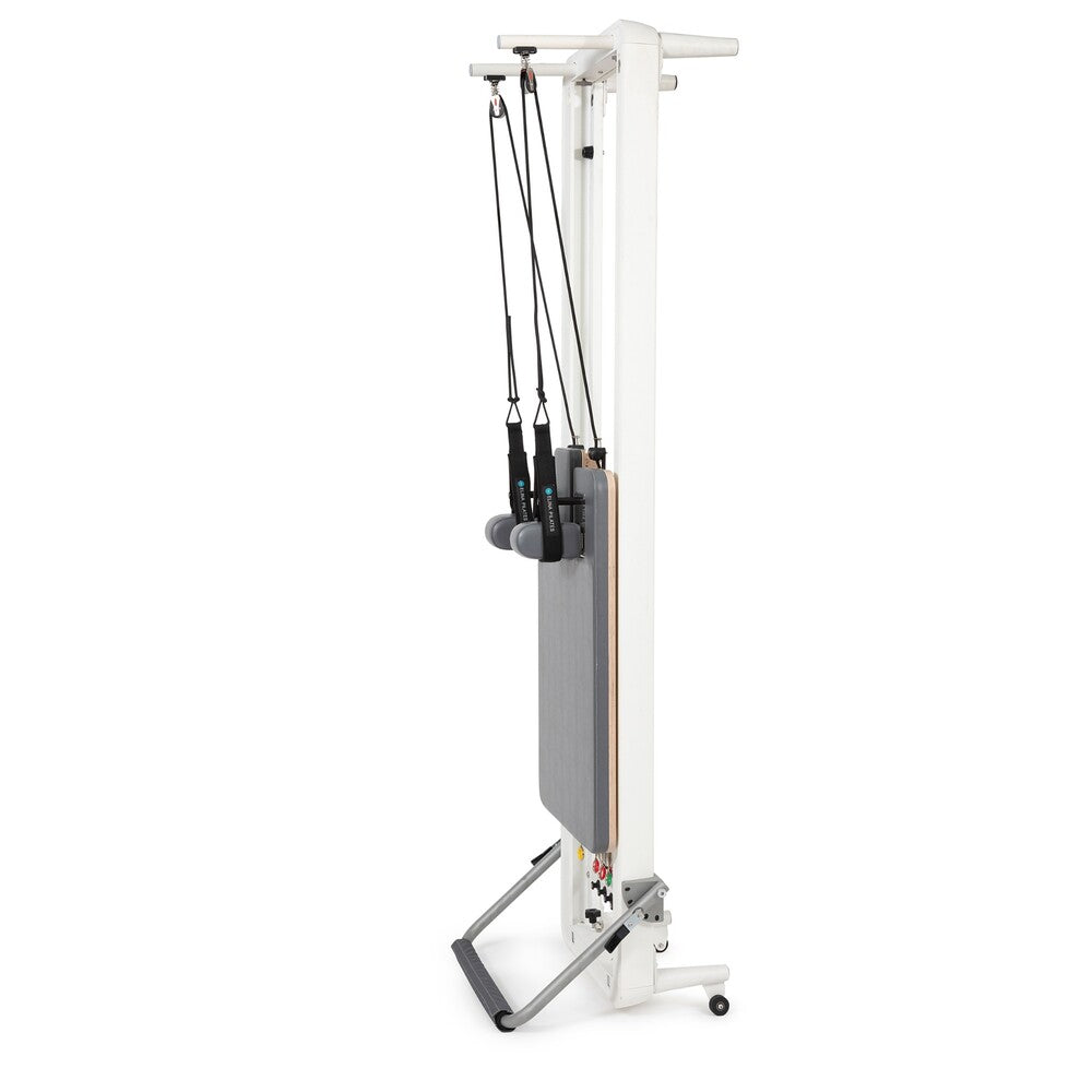 Elina Pilates Nubium reformer with gray upholstery stored vertically
