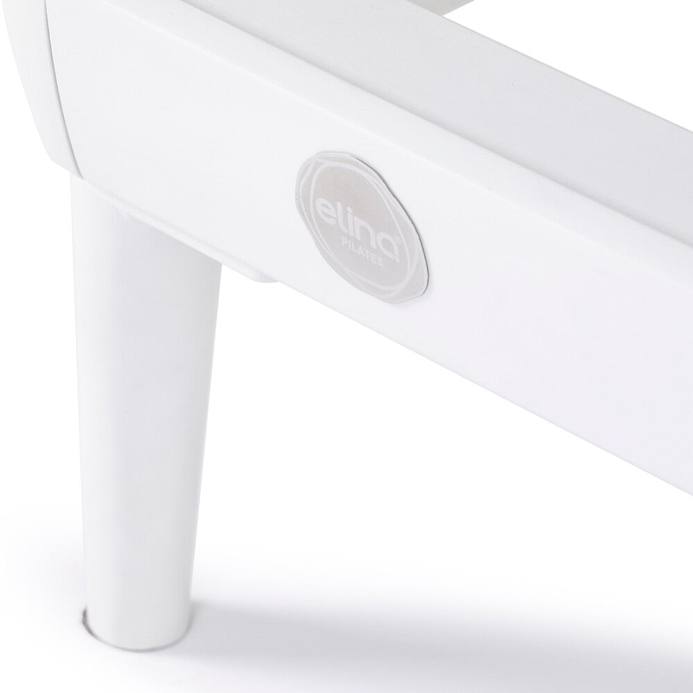 White aluminum frame and Elina Pilates badge on the Nubium reformer