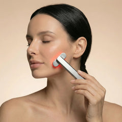 Woman with eyes closed using the Nicebeam 4-in-1 Skincare Wand on her jaw