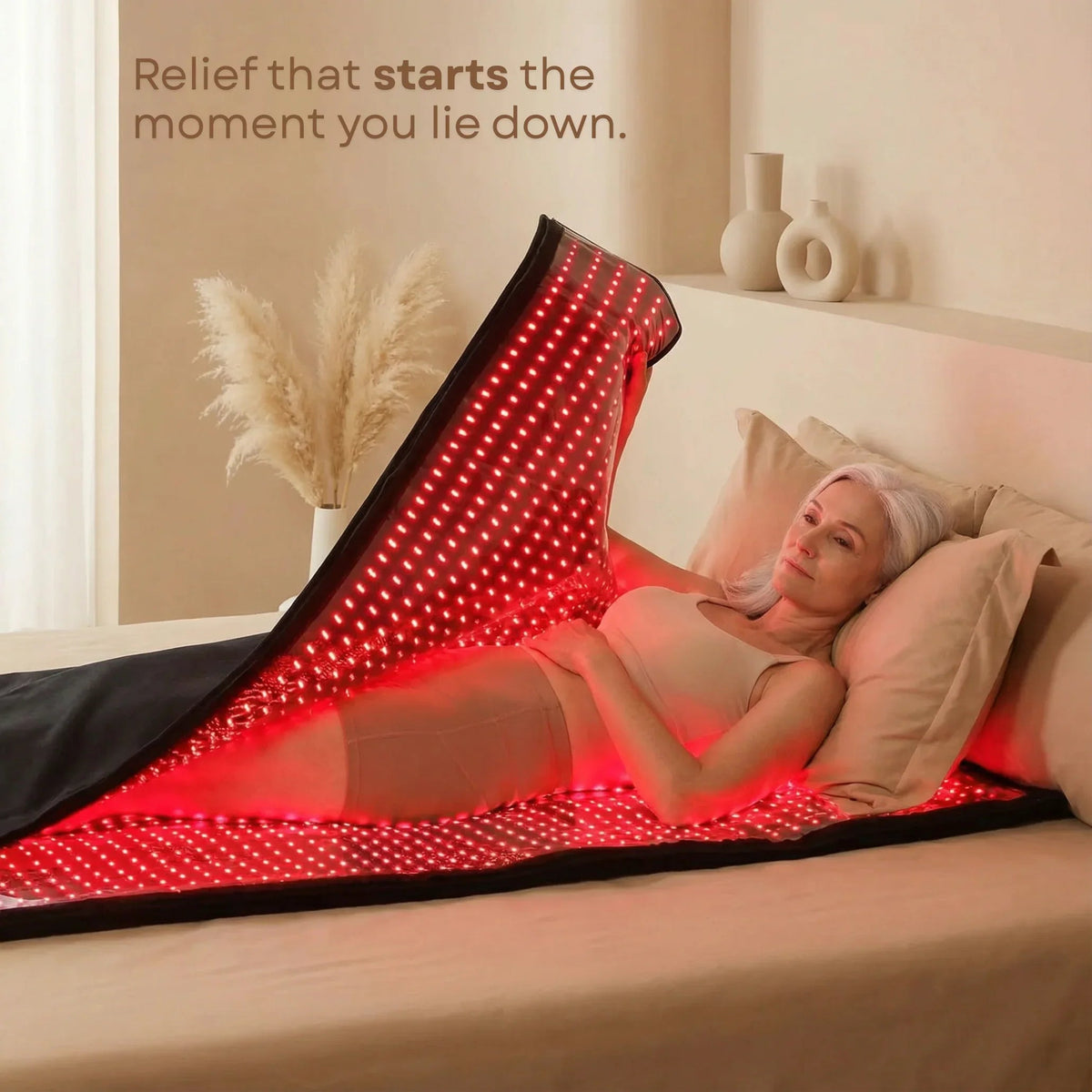 Woman lying inside the illuminated Nicebeam full body red light therapy bag