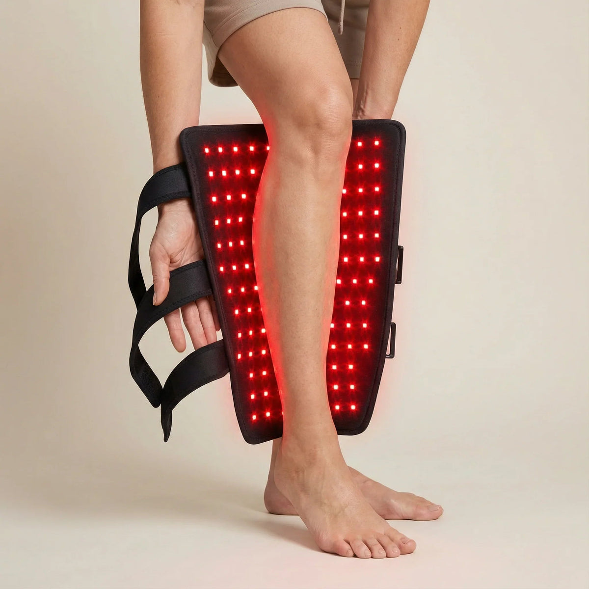 Person positioning the Nicebeam Leg Wrap Pro vertically around the lower leg