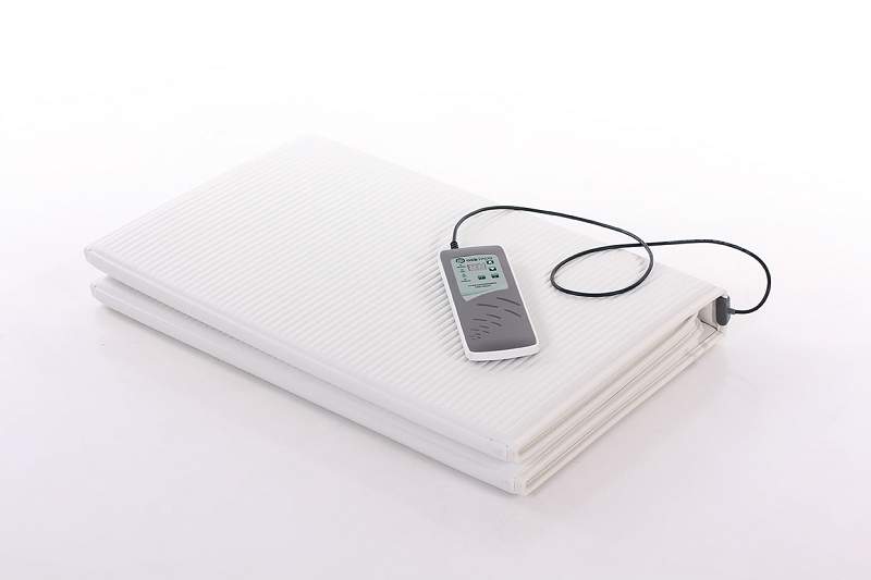 OMI PADS PEMF mat folded for storage with controller
