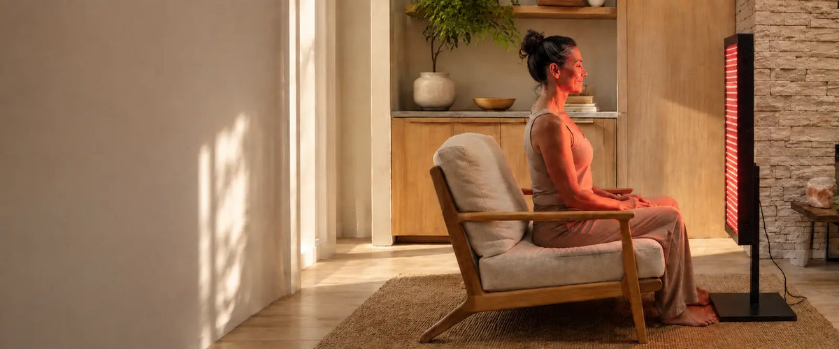 Woman using an LED light therapy device at home