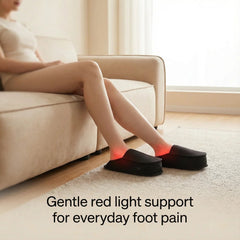 Woman on a sofa wearing Nicebeam Red Light Therapy Slippers with red light glowing