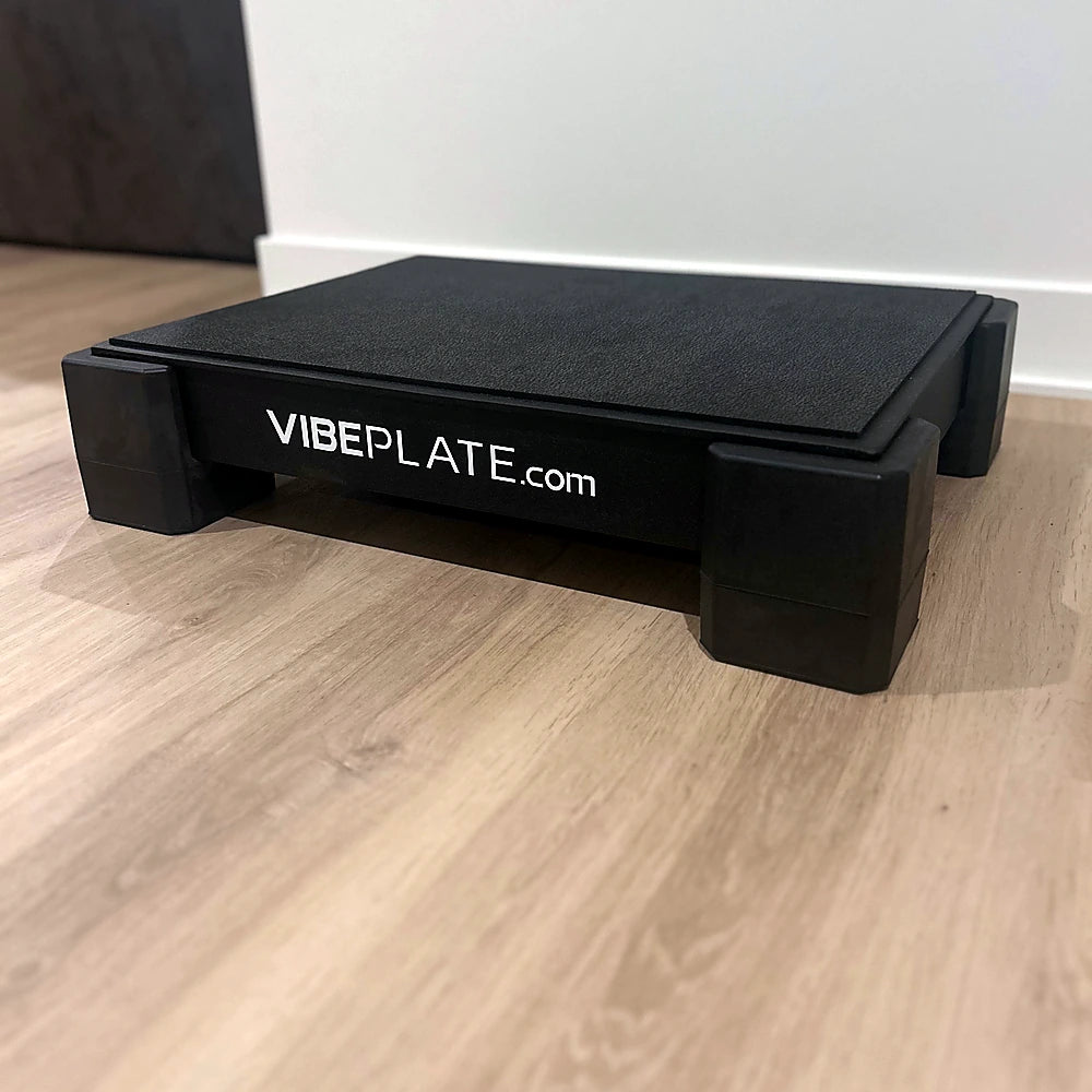 Angled view of the VibePlate 1824 in a home workout space