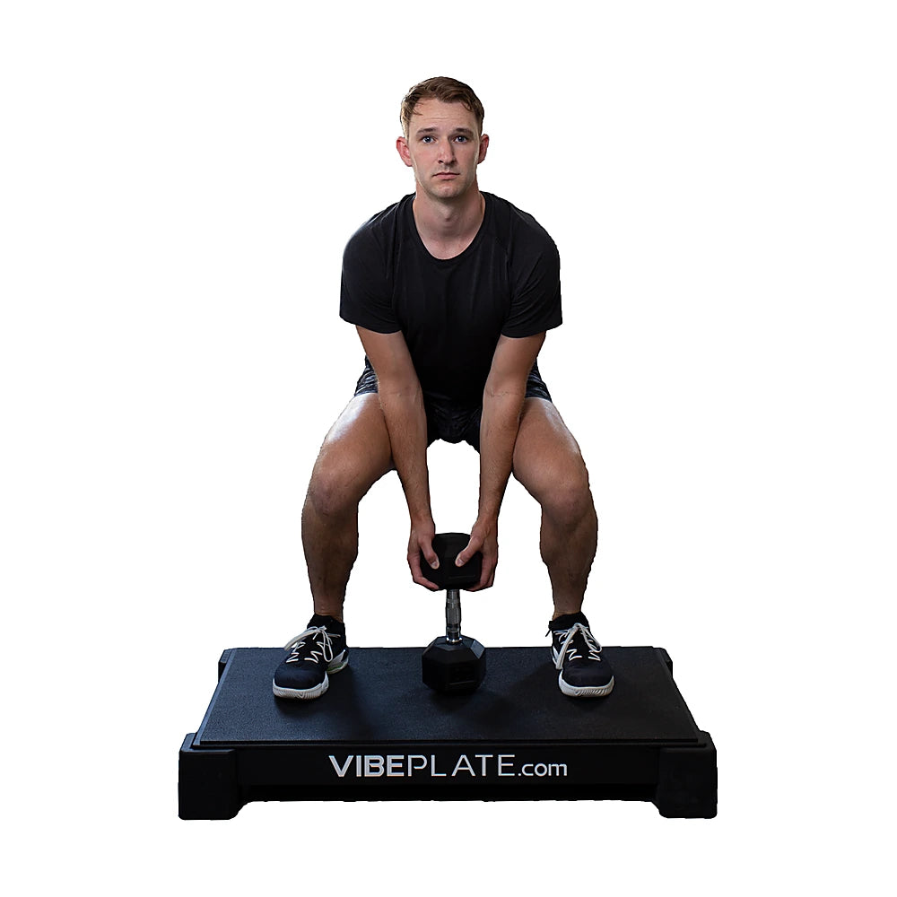 Man performing a kettlebell squat on the VibePlate 2440