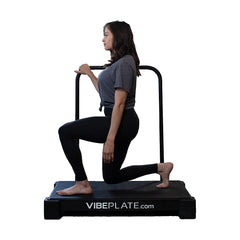 Woman performing a kneeling exercise on the VibePlate 2440 with balance bar