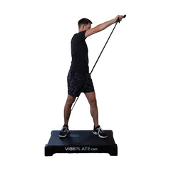 Man using resistance bands while standing on the VibePlate 2440