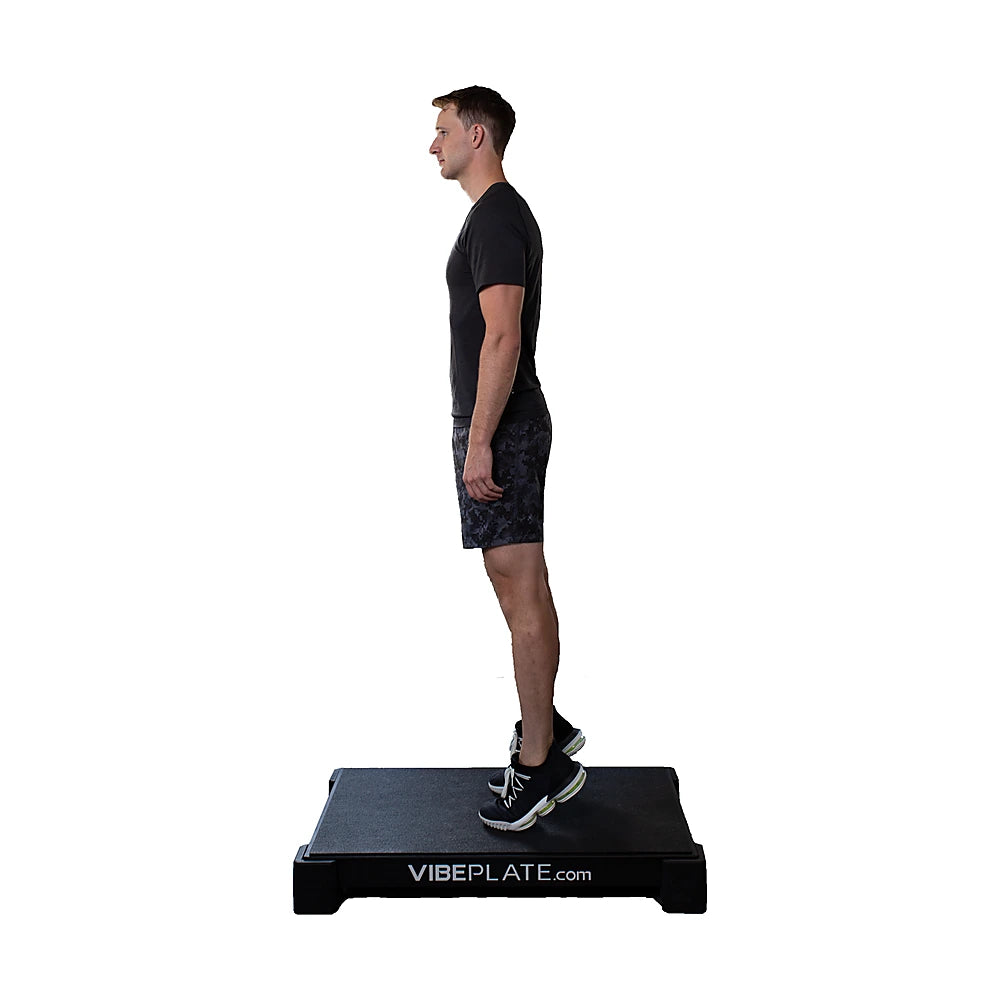 Man standing on the VibePlate 2440 vibration platform