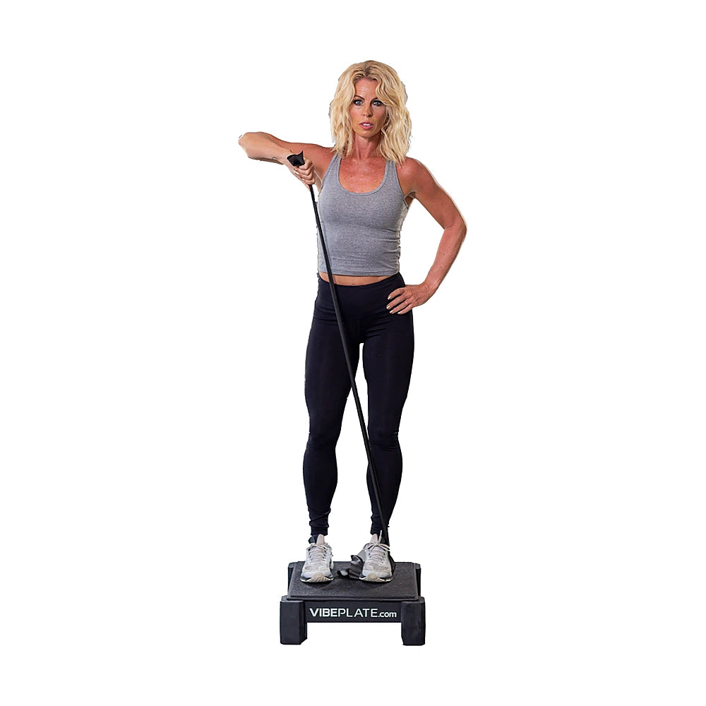 Woman using a resistance band while standing on the VibePlate Mini