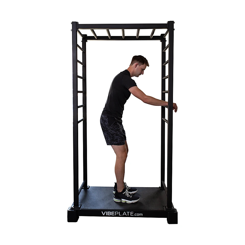 Man performing a standing rotation exercise on the VibeStretch