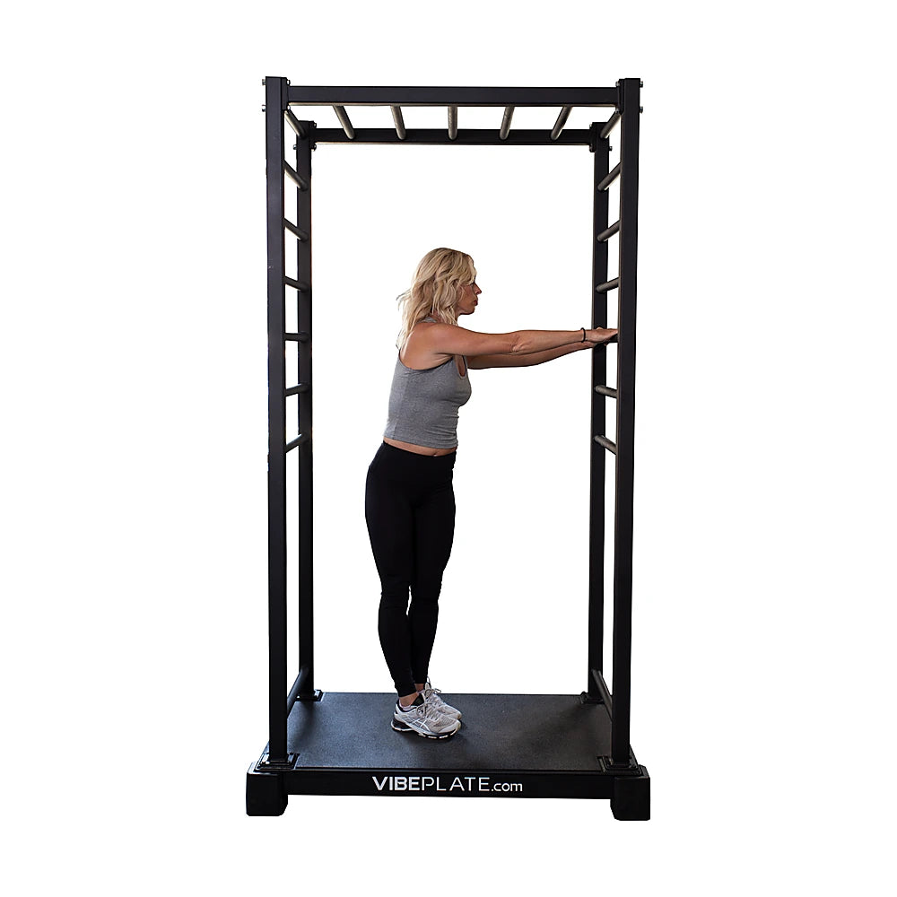 Woman performing a standing rotation exercise on the VibeStretch